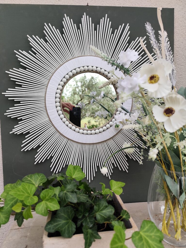 Miroir en bois naturel teinté de blanc et cerné de raphia et perles blanches Ju0199